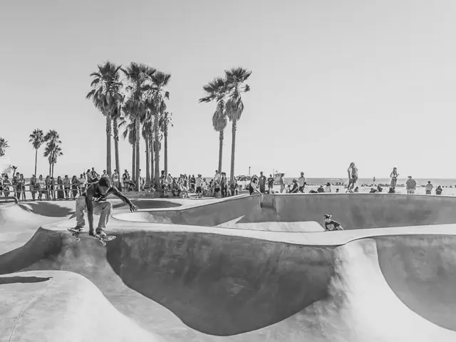 Skater carving a concrete bowl